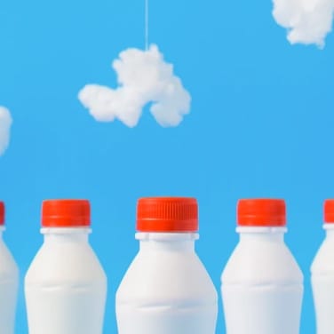 Artistic photo of milk bottles against a blue background